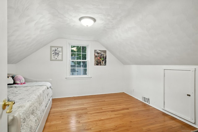 17 Wilstar Cir, Enfield, CT 06082 - bedroom featuring light wood-style flooring, lofted ceiling, and a textured ceiling