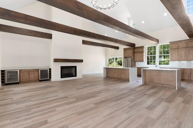 30 Tyrone Rd, Pomfret, CT 06259 - unfurnished living room featuring wine cooler, beam ceiling, high vaulted ceiling, light wood-style floors, and recessed lighting