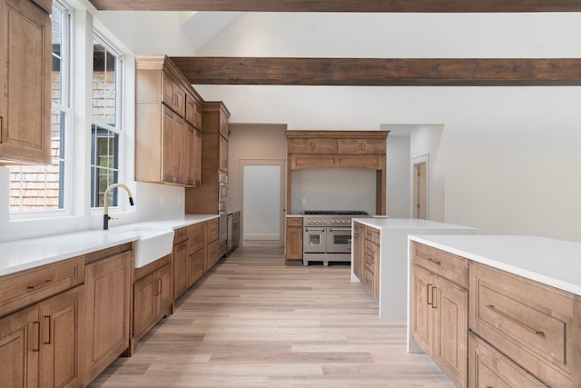 30 Tyrone Rd, Pomfret, CT 06259 - kitchen with double oven range, light wood-type flooring, light countertops, brown cabinets, and beam ceiling