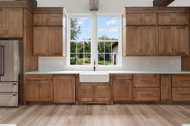 30 Tyrone Rd, Pomfret, CT 06259 - kitchen with freestanding refrigerator, brown cabinetry, light wood-type flooring, and light countertops