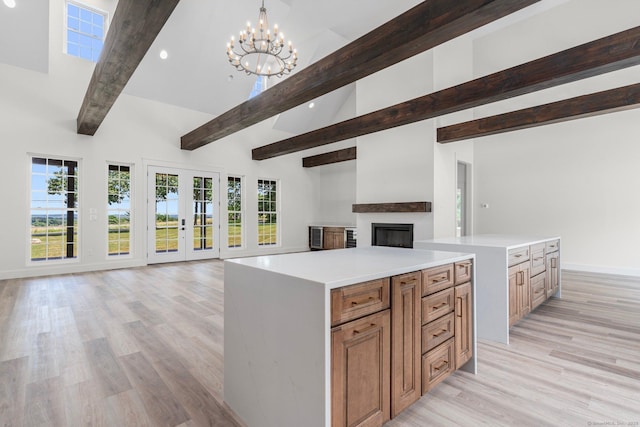 30 Tyrone Rd, Pomfret, CT 06259 - kitchen with open floor plan, beam ceiling, a fireplace, a chandelier, and a kitchen island