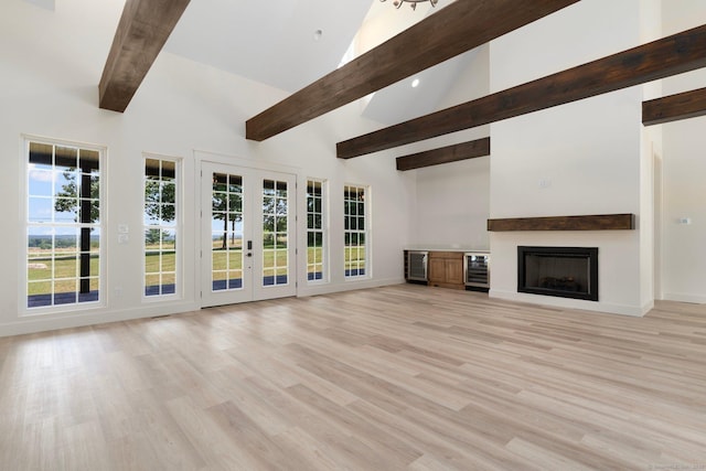 30 Tyrone Rd, Pomfret, CT 06259 - unfurnished living room featuring wine cooler, beam ceiling, high vaulted ceiling, light wood finished floors, and french doors
