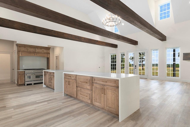 30 Tyrone Rd, Pomfret, CT 06259 - kitchen with range with two ovens, high vaulted ceiling, light wood-style flooring, a chandelier, and open floor plan