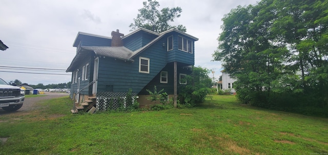 127 S Main St, East Windsor, CT 06088 - view of side of property featuring a yard and a chimney