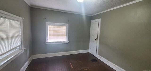 127 S Main St, East Windsor, CT 06088 - spare room featuring dark wood-type flooring, ornamental molding, and a textured ceiling