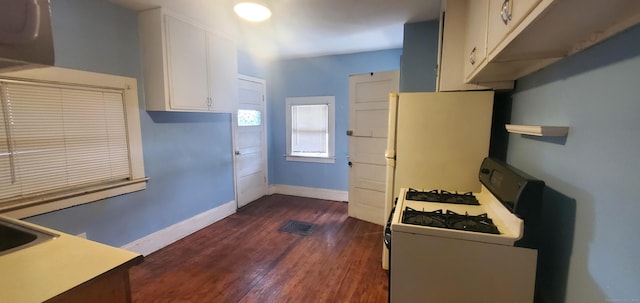127 S Main St, East Windsor, CT 06088 - kitchen with white gas stove, dark wood-style flooring, white cabinets, and light countertops