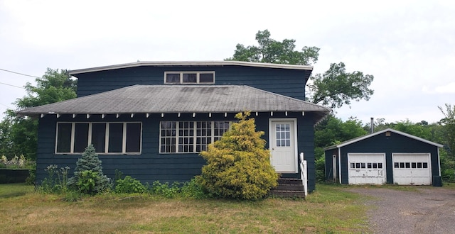 127 S Main St, East Windsor, CT 06088 - view of front of property with an outbuilding, a detached garage, and a shingled roof