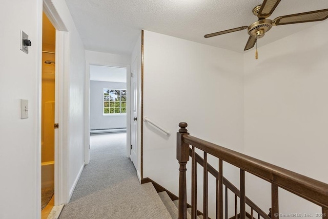 241 Judith Ln Unit 2, Waterbury, CT 06704 - hall with baseboard heating, an upstairs landing, light carpet, and a textured ceiling