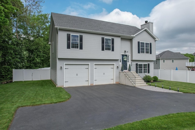 105 Hidden Pines Cir, Meriden, CT 06451 - bi-level home featuring a chimney, asphalt driveway, and an attached garage
