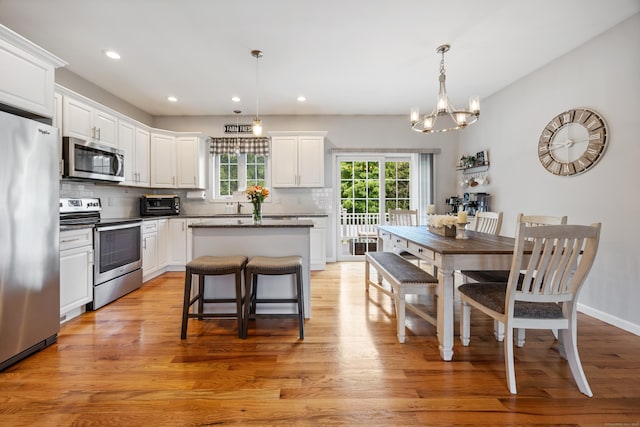 105 Hidden Pines Cir, Meriden, CT 06451 - kitchen featuring stainless steel appliances, decorative backsplash, white cabinets, a kitchen island, and recessed lighting