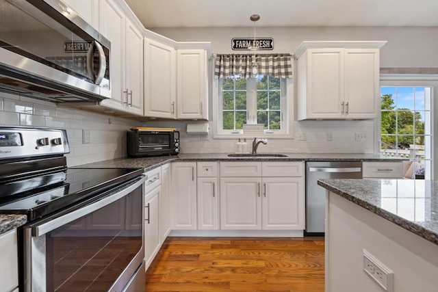 105 Hidden Pines Cir, Meriden, CT 06451 - kitchen featuring stainless steel appliances, white cabinetry, and plenty of natural light
