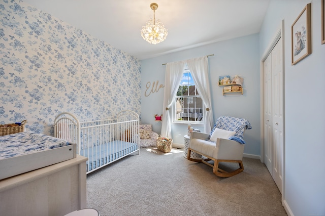 105 Hidden Pines Cir, Meriden, CT 06451 - carpeted bedroom with a chandelier, wallpapered walls, a crib, and a closet