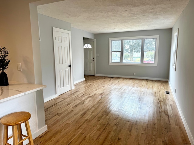 179 Mcgrath Ct, Stratford, CT 06615 - living room featuring a textured ceiling and wood finished floors