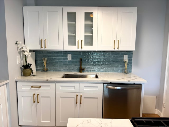 179 Mcgrath Ct, Stratford, CT 06615 - kitchen with stainless steel dishwasher, white cabinets, tasteful backsplash, glass insert cabinets, and light stone countertops