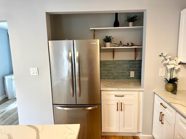 179 Mcgrath Ct, Stratford, CT 06615 - kitchen with freestanding refrigerator, light stone counters, white cabinets, open shelves, and light wood-style flooring