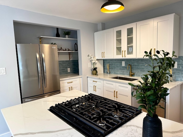 179 Mcgrath Ct, Stratford, CT 06615 - kitchen with freestanding refrigerator, light stone countertops, tasteful backsplash, glass insert cabinets, and white cabinets