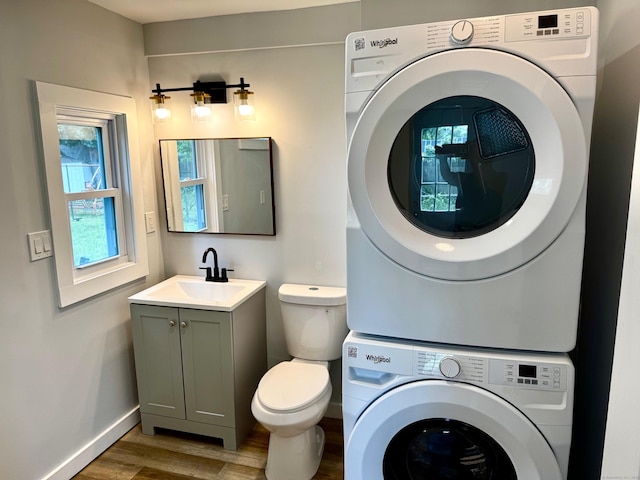 179 Mcgrath Ct, Stratford, CT 06615 - bathroom with stacked washer and clothes dryer, wood finished floors, and vanity