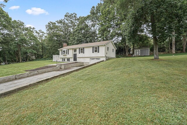 471 Moosup Pond Rd, Plainfield, CT 06354 - view of front facade featuring a garage, a storage unit, a chimney, driveway, and a front yard