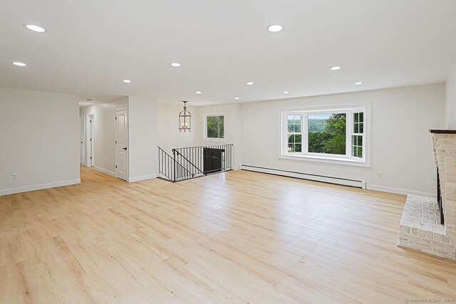 471 Moosup Pond Rd, Plainfield, CT 06354 - unfurnished living room with a baseboard radiator, light wood finished floors, recessed lighting, and a fireplace