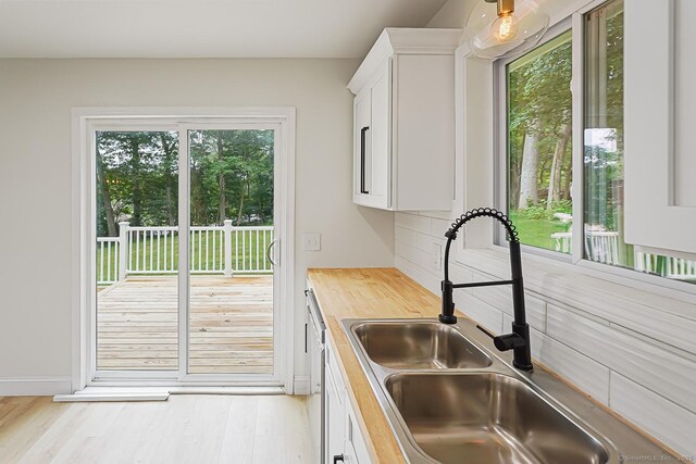 471 Moosup Pond Rd, Plainfield, CT 06354 - kitchen featuring white cabinetry, wood counters, tasteful backsplash, and light wood-style flooring