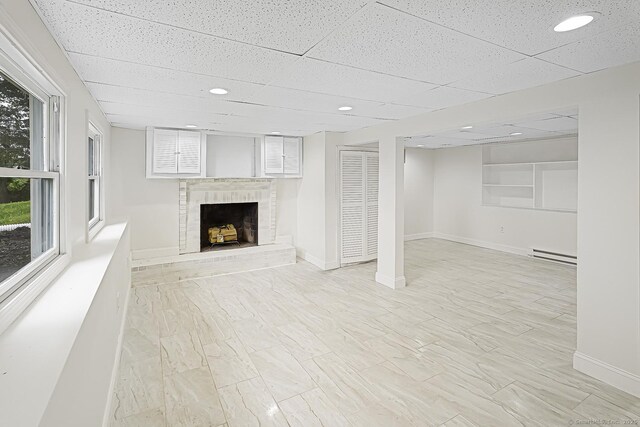 471 Moosup Pond Rd, Plainfield, CT 06354 - below grade area featuring a baseboard radiator, a fireplace, a paneled ceiling, and recessed lighting