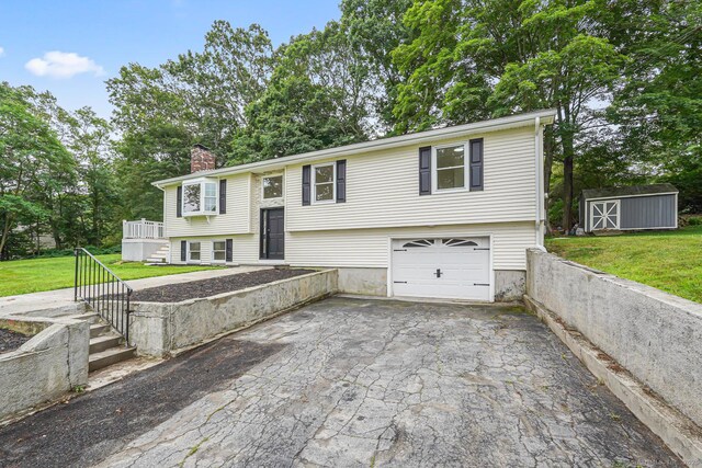 471 Moosup Pond Rd, Plainfield, CT 06354 - raised ranch featuring a chimney, driveway, a front yard, and stairway