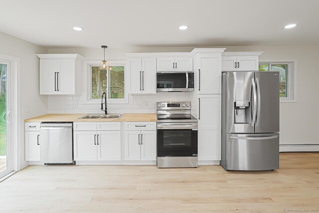 471 Moosup Pond Rd, Plainfield, CT 06354 - kitchen with appliances with stainless steel finishes, baseboard heating, backsplash, white cabinetry, and recessed lighting