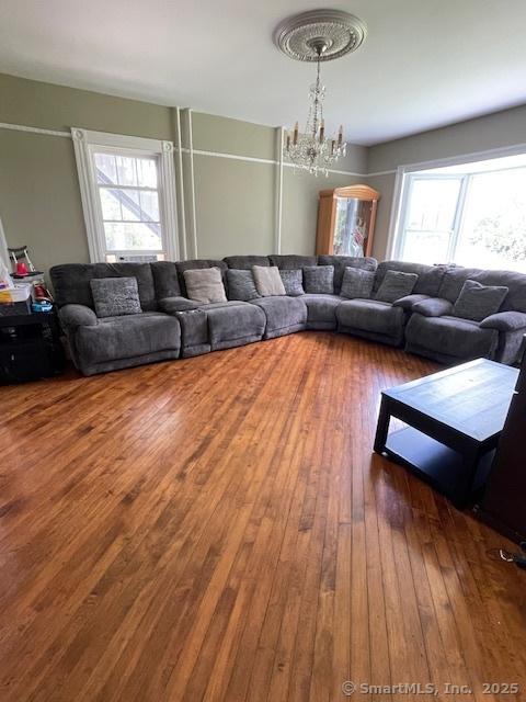 2 Judd Ave, Bethel, CT 06801 - living room featuring a chandelier, healthy amount of natural light, and hardwood / wood-style floors