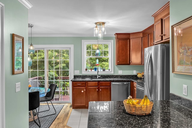 41 Palmer St Unit 20, Norwich, CT 06360 - kitchen featuring appliances with stainless steel finishes, dark stone countertops, brown cabinets, crown molding, and pendant lighting