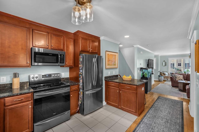 41 Palmer St Unit 20, Norwich, CT 06360 - kitchen featuring stainless steel appliances, a peninsula, open floor plan, crown molding, and brown cabinetry