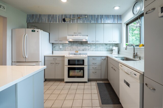 143 Sandy Point Rd Unit 143, Old Saybrook, CT 06475 - kitchen with white appliances, under cabinet range hood, backsplash, light tile patterned flooring, and recessed lighting
