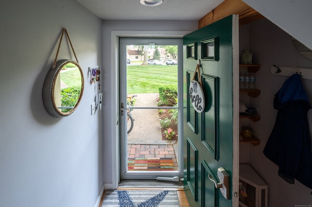 143 Sandy Point Rd Unit 143, Old Saybrook, CT 06475 - entryway featuring wood finished floors and a textured ceiling