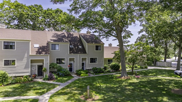 143 Sandy Point Rd Unit 143, Old Saybrook, CT 06475 - view of front of property with a front yard, a chimney, and roof with shingles