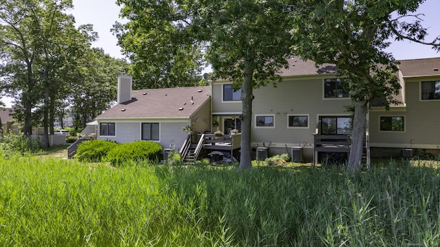 143 Sandy Point Rd Unit 143, Old Saybrook, CT 06475 - back of house with a wooden deck and a chimney
