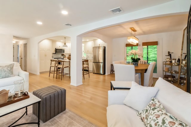 59 Flint Ridge Rd, Monroe, CT 06468 - living room featuring arched walkways, light wood-type flooring, and recessed lighting