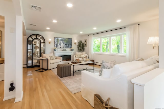 59 Flint Ridge Rd, Monroe, CT 06468 - living area with light wood-style floors, recessed lighting, a glass covered fireplace, and baseboard heating