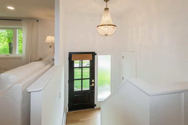 59 Flint Ridge Rd, Monroe, CT 06468 - entrance foyer featuring healthy amount of natural light, a chandelier, and wood finished floors