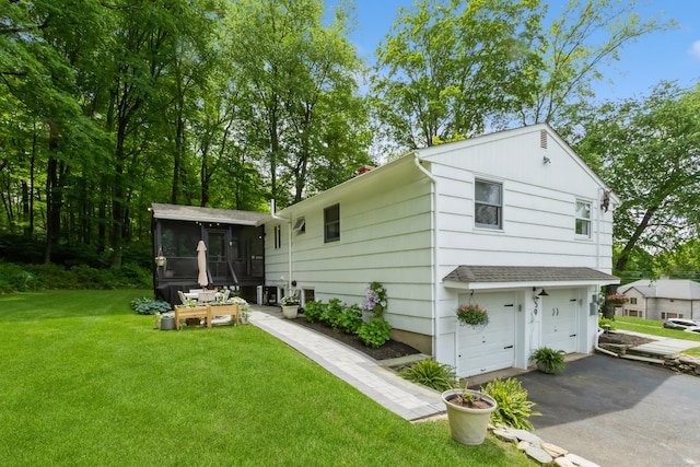 59 Flint Ridge Rd, Monroe, CT 06468 - back of house with a sunroom, driveway, a garage, and a yard