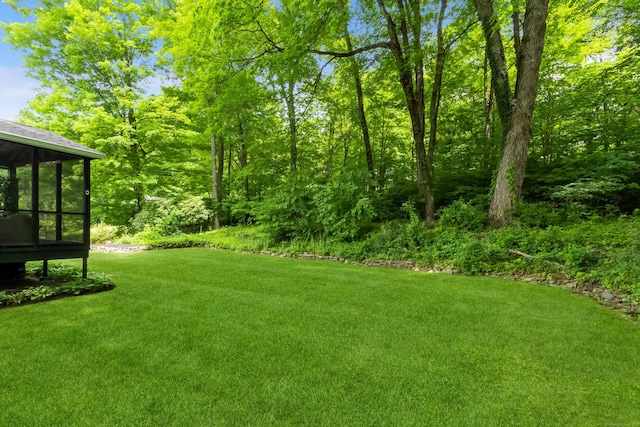 59 Flint Ridge Rd, Monroe, CT 06468 - view of green lawn featuring a sunroom