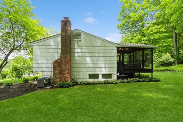 59 Flint Ridge Rd, Monroe, CT 06468 - view of property exterior featuring a sunroom, a yard, and a chimney