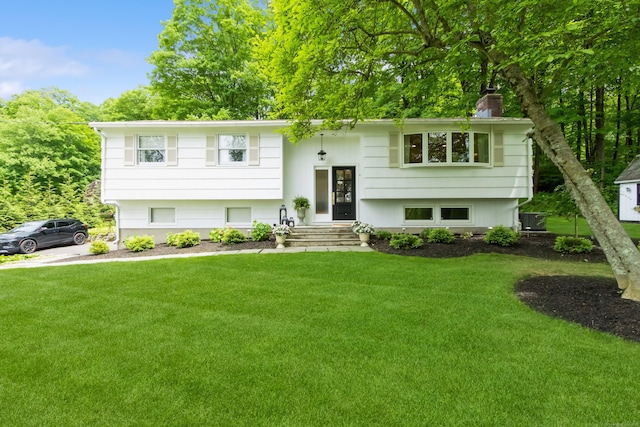 59 Flint Ridge Rd, Monroe, CT 06468 - raised ranch featuring a front lawn and a chimney