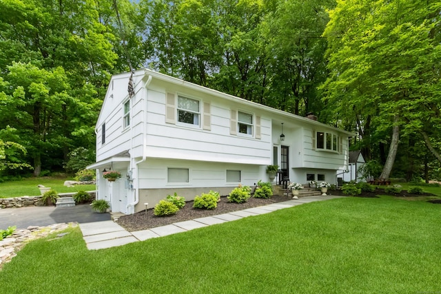 59 Flint Ridge Rd, Monroe, CT 06468 - split foyer home featuring a front lawn and view of wooded area