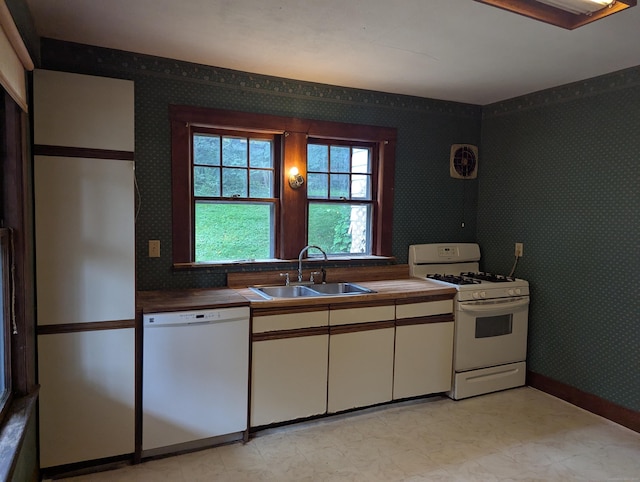 10 Staples St, Danbury, CT 06810 - kitchen with white appliances, wallpapered walls, white cabinets, and light flooring