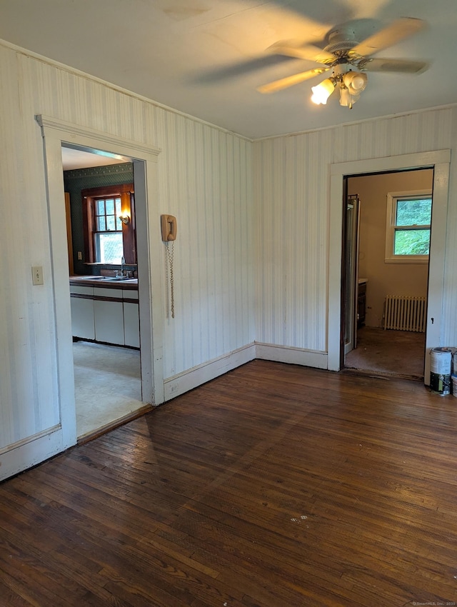 10 Staples St, Danbury, CT 06810 - empty room with radiator, dark wood finished floors, and a ceiling fan