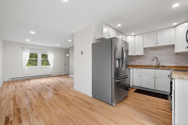 11 Fawn Rdg, Woodstock, CT 06281 - kitchen with stainless steel refrigerator with ice dispenser, a baseboard radiator, butcher block counters, backsplash, and white cabinetry