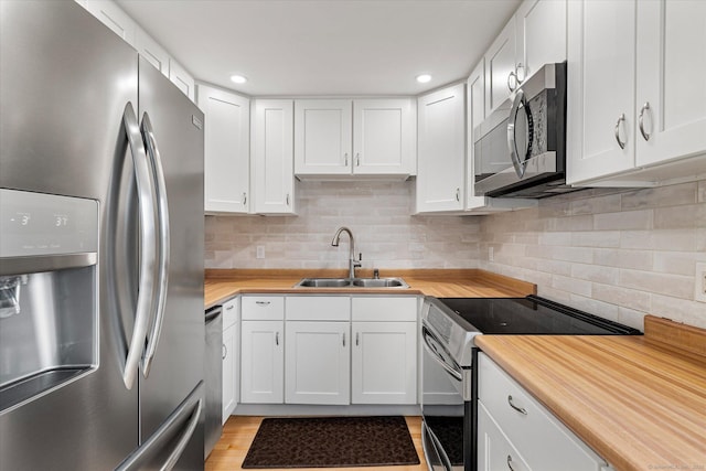 11 Fawn Rdg, Woodstock, CT 06281 - kitchen with appliances with stainless steel finishes, white cabinets, backsplash, light wood finished floors, and recessed lighting