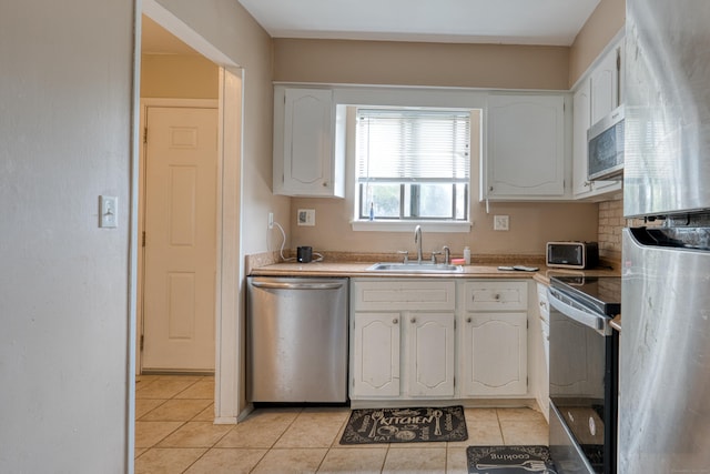 560 Yale Ave Unit 209, Meriden, CT 06450 - kitchen with appliances with stainless steel finishes, light tile patterned floors, white cabinets, and light countertops