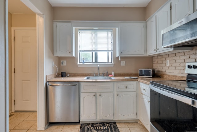 560 Yale Ave Unit 209, Meriden, CT 06450 - kitchen with appliances with stainless steel finishes, white cabinetry, light tile patterned floors, light countertops, and decorative backsplash