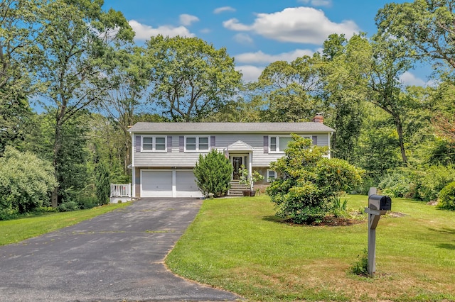 59 Laurel Wood Dr, Shelton, CT 06484 - raised ranch with asphalt driveway, a garage, a chimney, and a front yard
