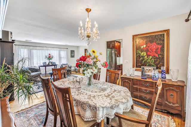 59 Laurel Wood Dr, Shelton, CT 06484 - dining room with a chandelier and wood finished floors